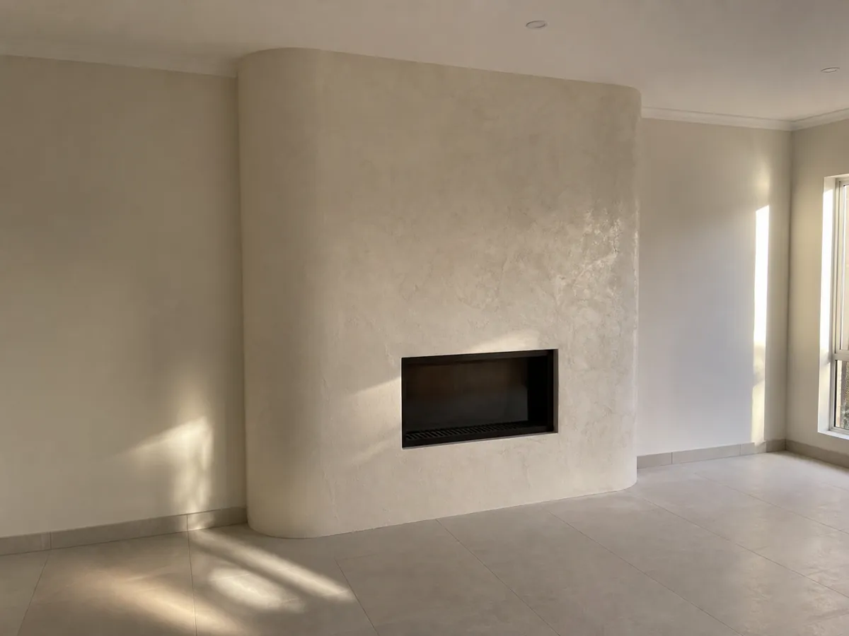 Textured plaster fireplace feature completed in Kuraby