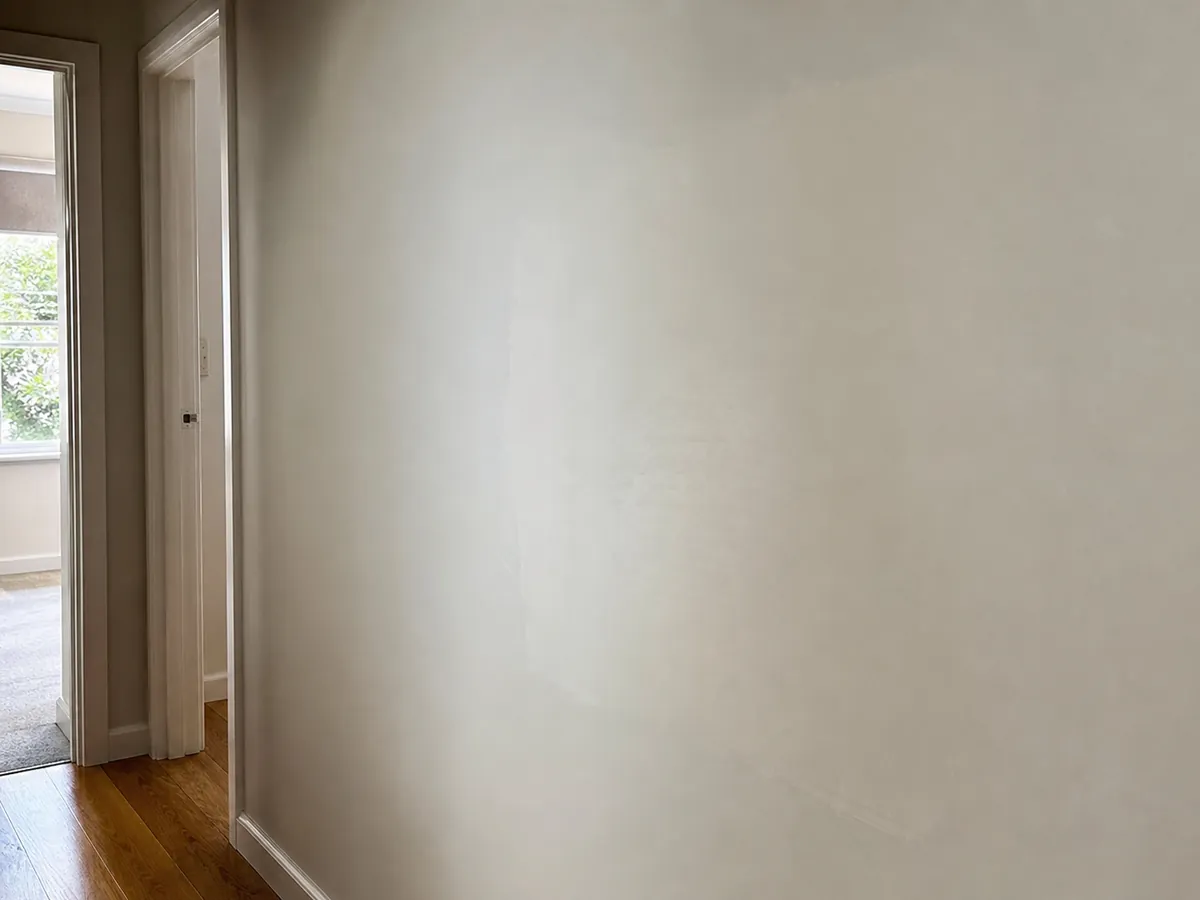Smoothly blended plaster wall repair in a Brisbane hallway